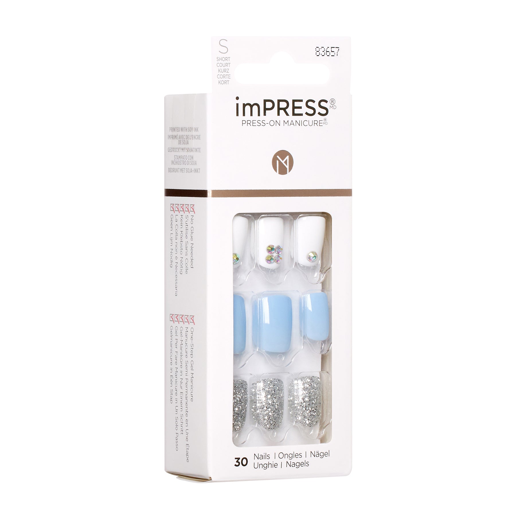 KIM006C_extra_005 "A package of imPRESS Press-On Manicure nails. The packaging is primarily white with some brown accents and features a clear window through which the nails can be seen. The set includes 30 nails in various designs: some are solid light blue, some are white with small decorative gems, and others are covered in silver glitter."